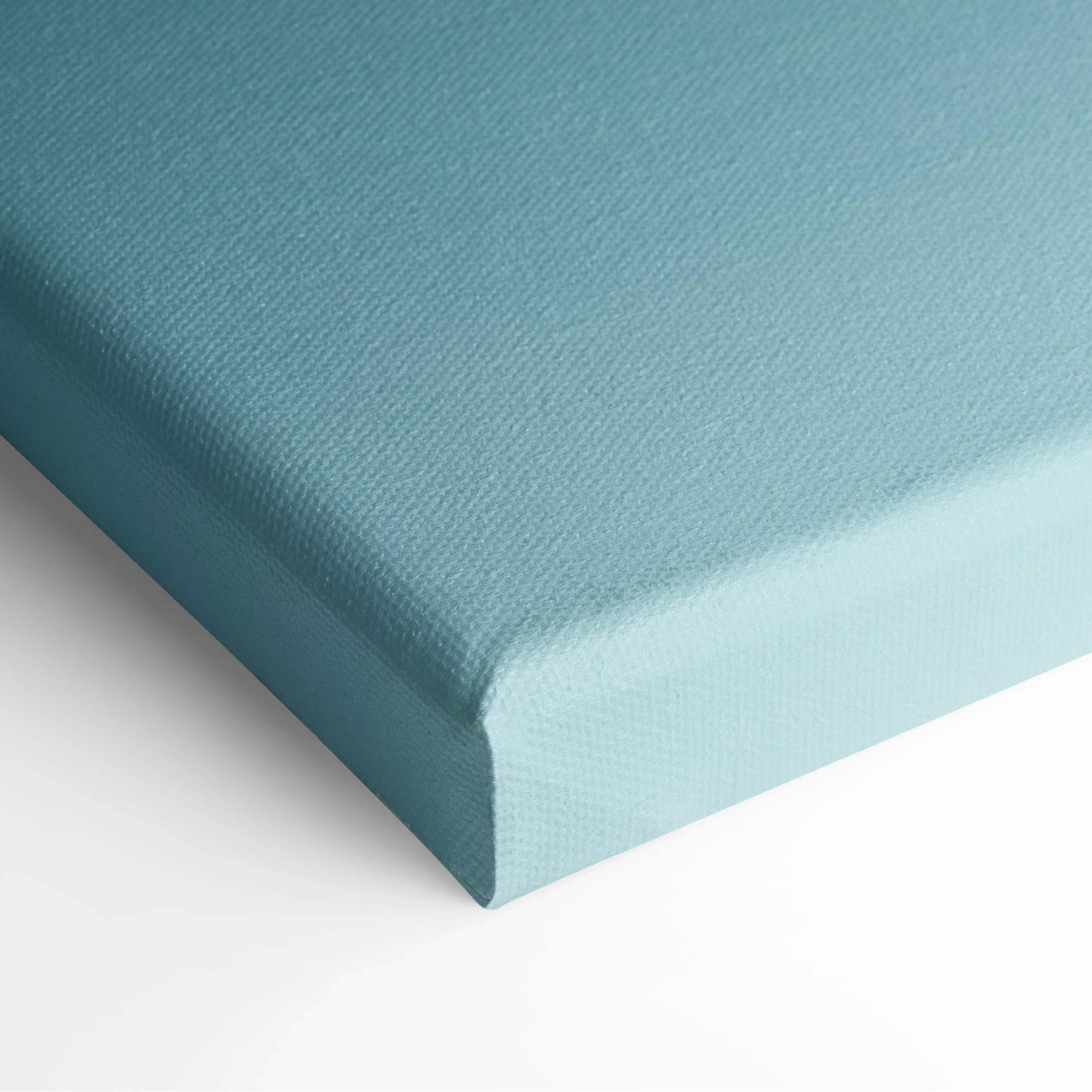 Close-up of light blue canvas wall art with textured fabric and clean edge wrapping.