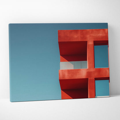 Canvas wall art featuring a red geometric building facade against a clear blue sky.