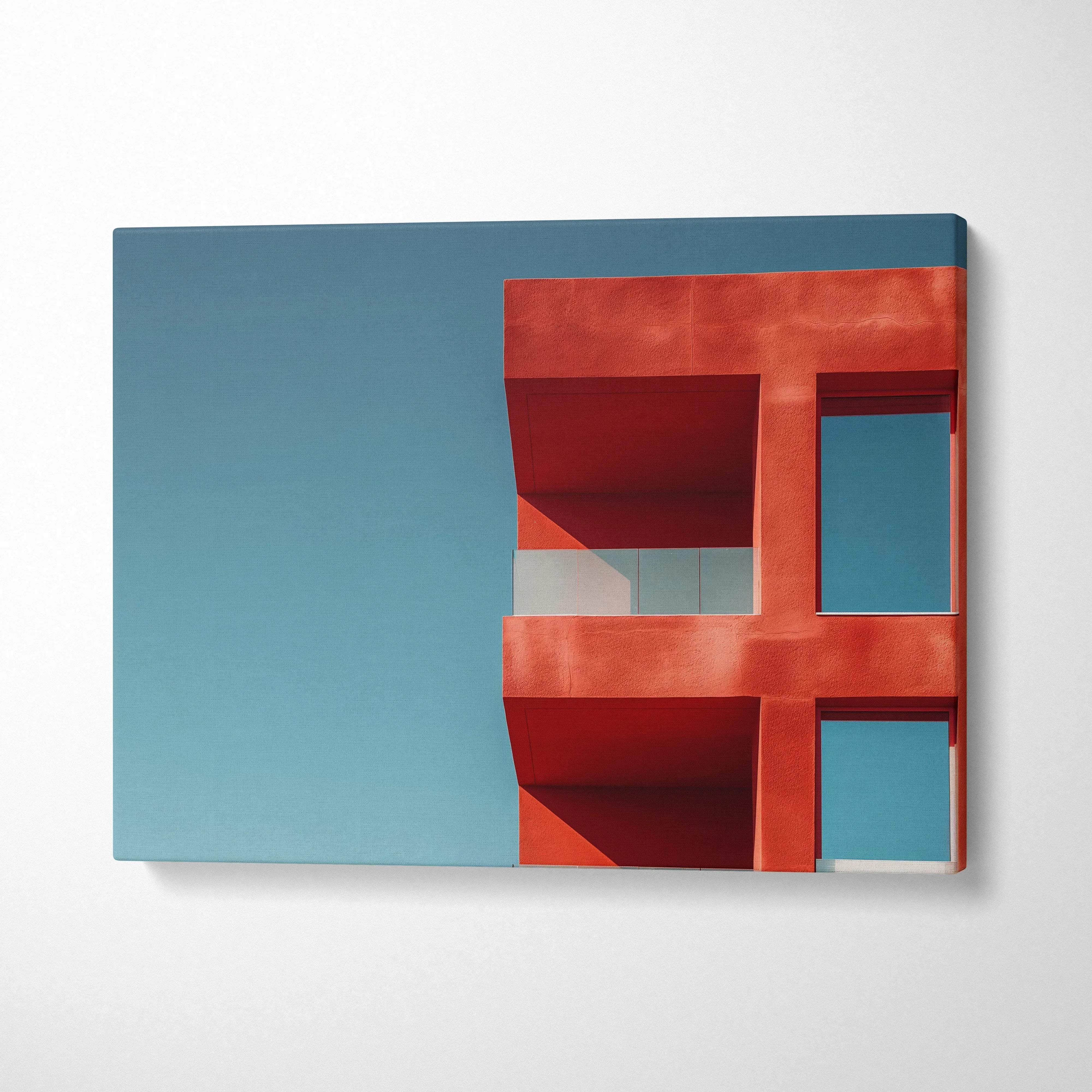 Red modern architectural building against clear blue sky canvas wall art print.