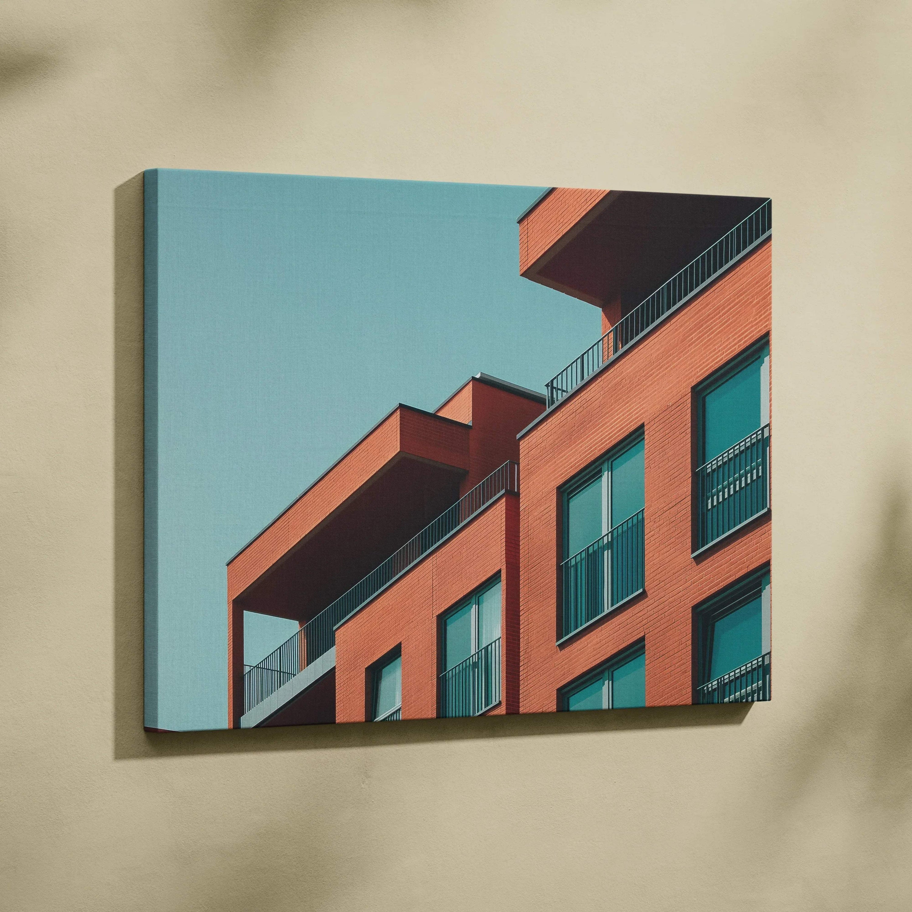 Modern architectural building canvas art with red and glass facade against blue sky wall art.