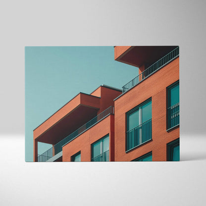 Modern building architecture in vibrant orange tones on canvas wall art with clear turquoise sky background.