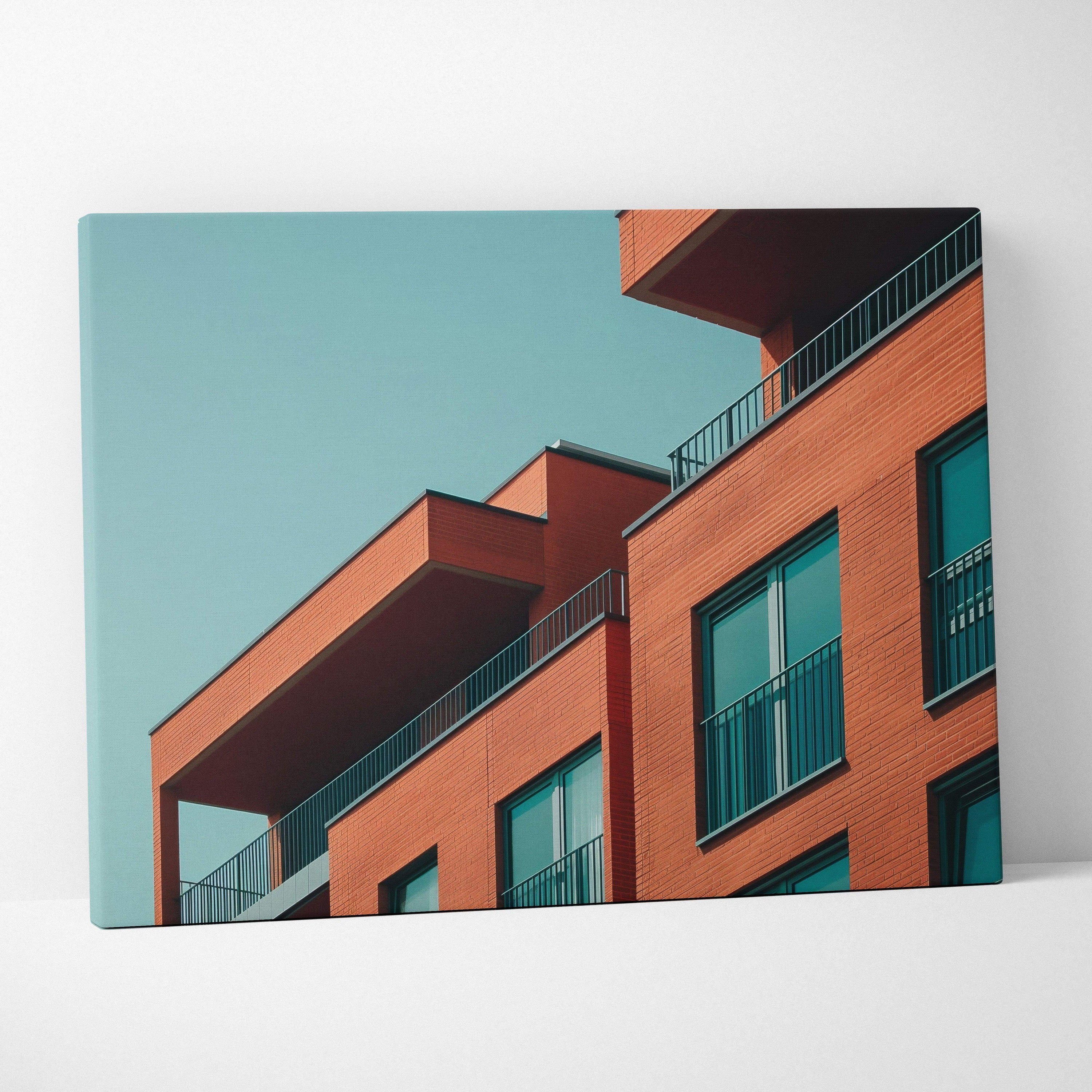 Modern building digital art on canvas wall art with orange and teal tones.