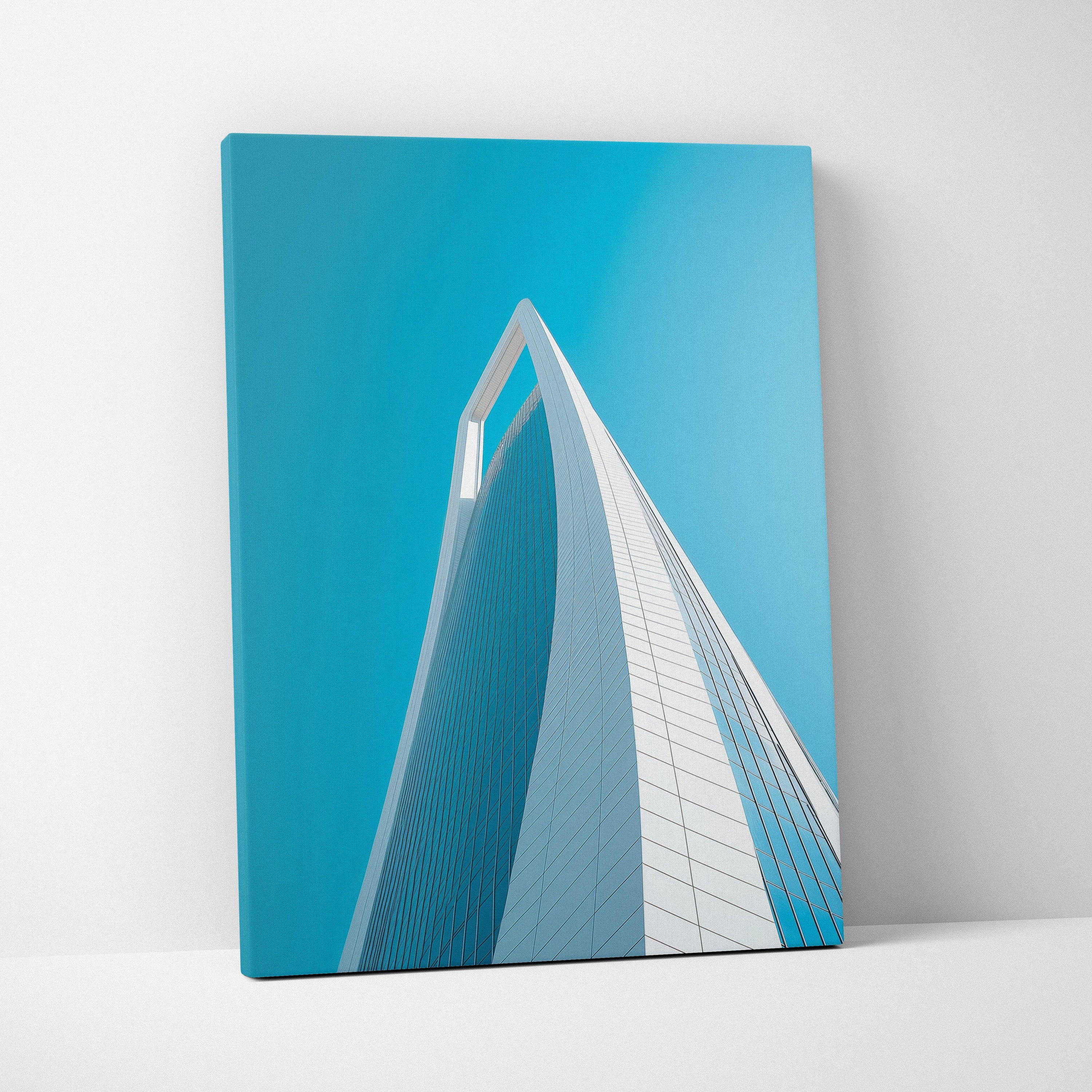 Vertical canvas wall art featuring modern skyscraper architecture against a clear blue sky.