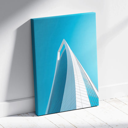 Vertical canvas art featuring modern white skyscraper against bright blue sky for wall art decor.