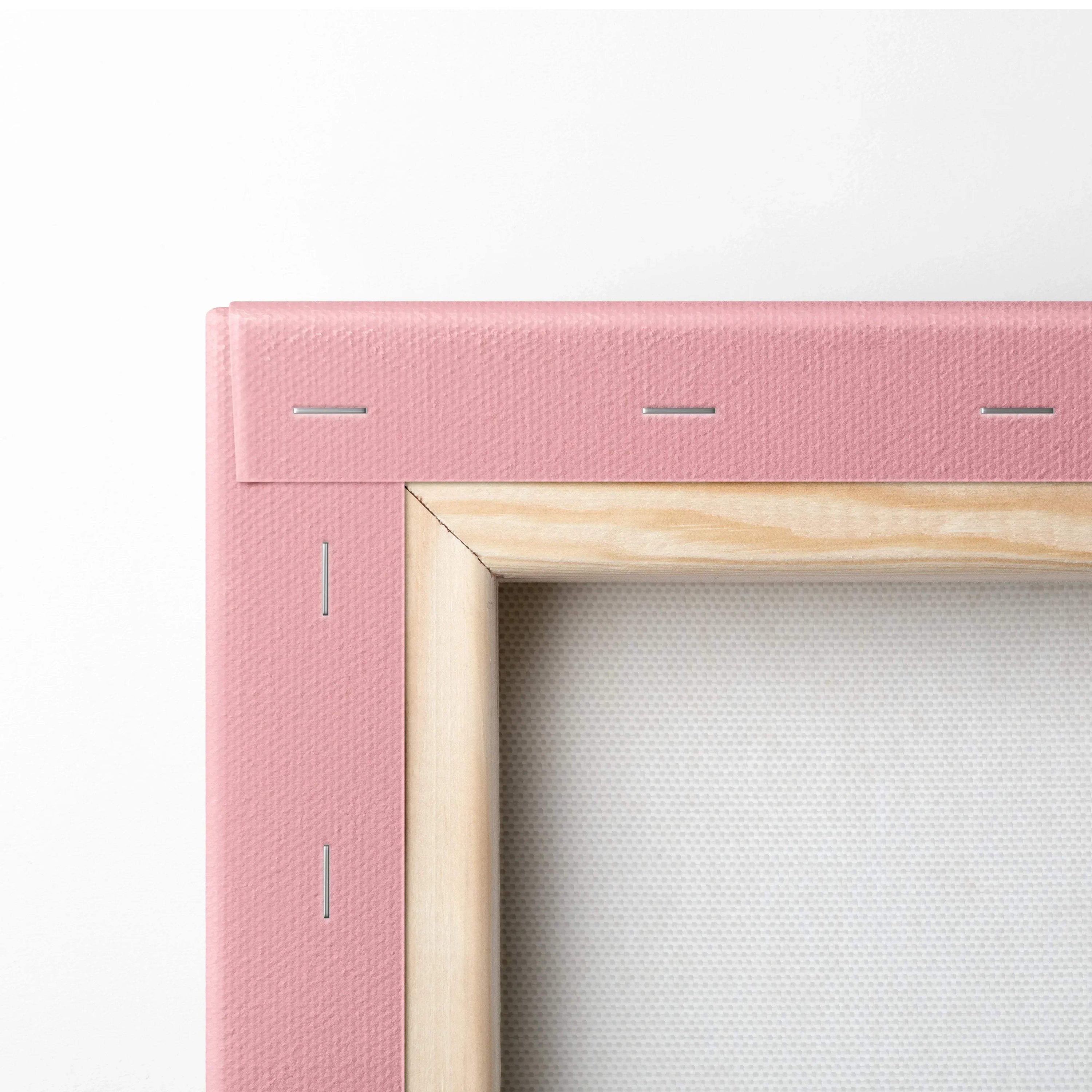 Close-up of a pink-stretched canvas with wooden frame and metal staples, showing texture and corner detail.