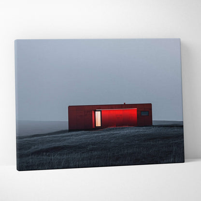 Canvas wall art featuring a minimalist modern red building on a dark, grassy landscape under a gray sky.