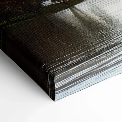 Close-up of dark textured canvas art wrapped around wooden frame with subtle architectural shadows on surface.