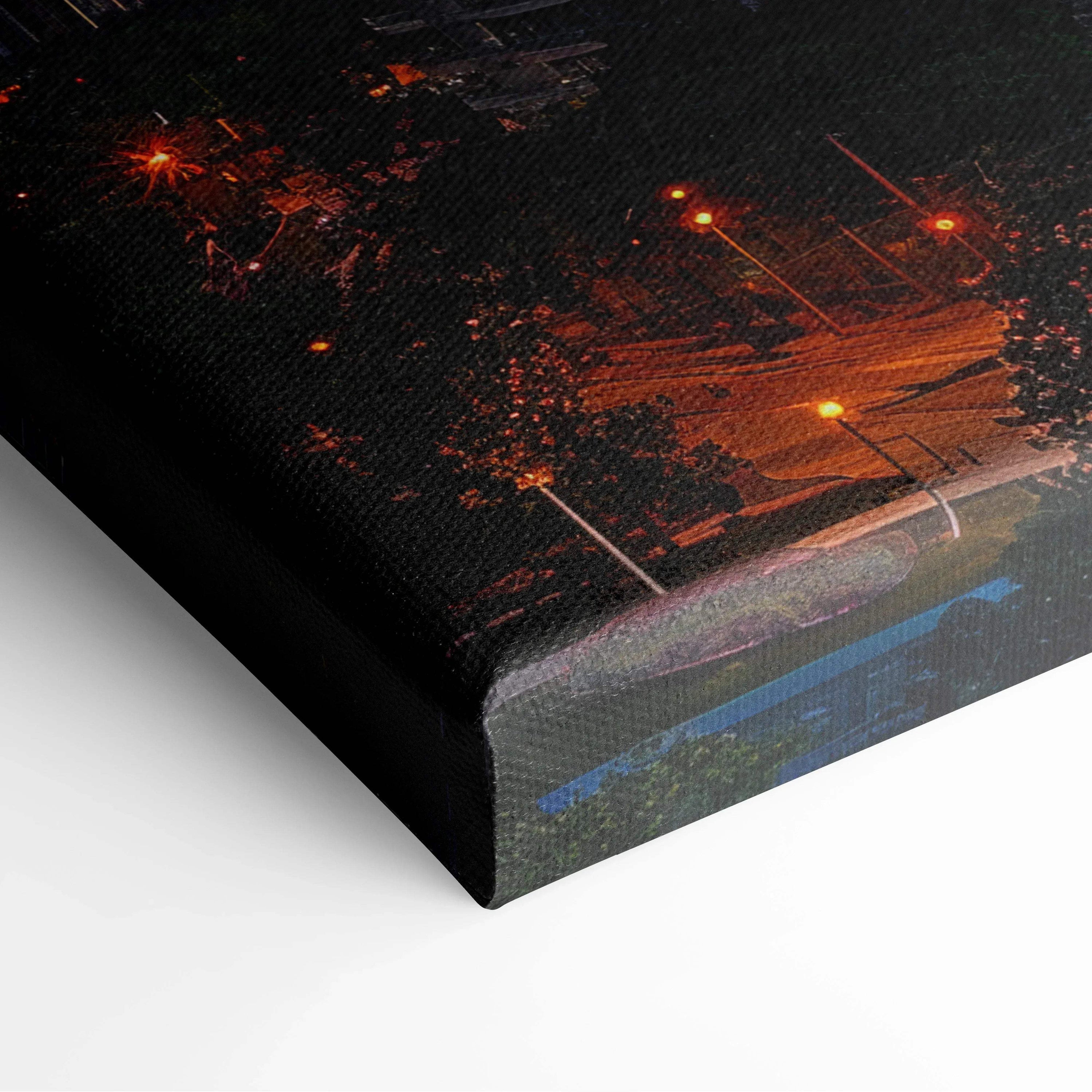 Close-up of black and orange digital canvas wall art with illuminated architectural design and textured finish.