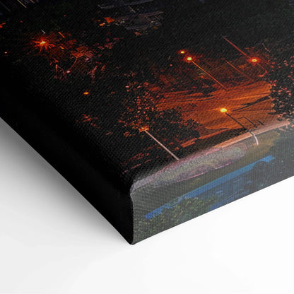 Close-up of black and orange digital canvas wall art with illuminated architectural design and textured finish.