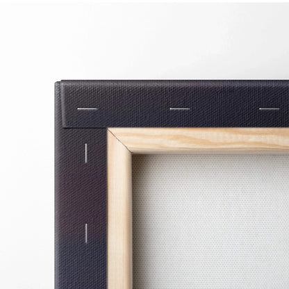 Close-up of wooden frame corner with black canvas stapled on back of wall art print.