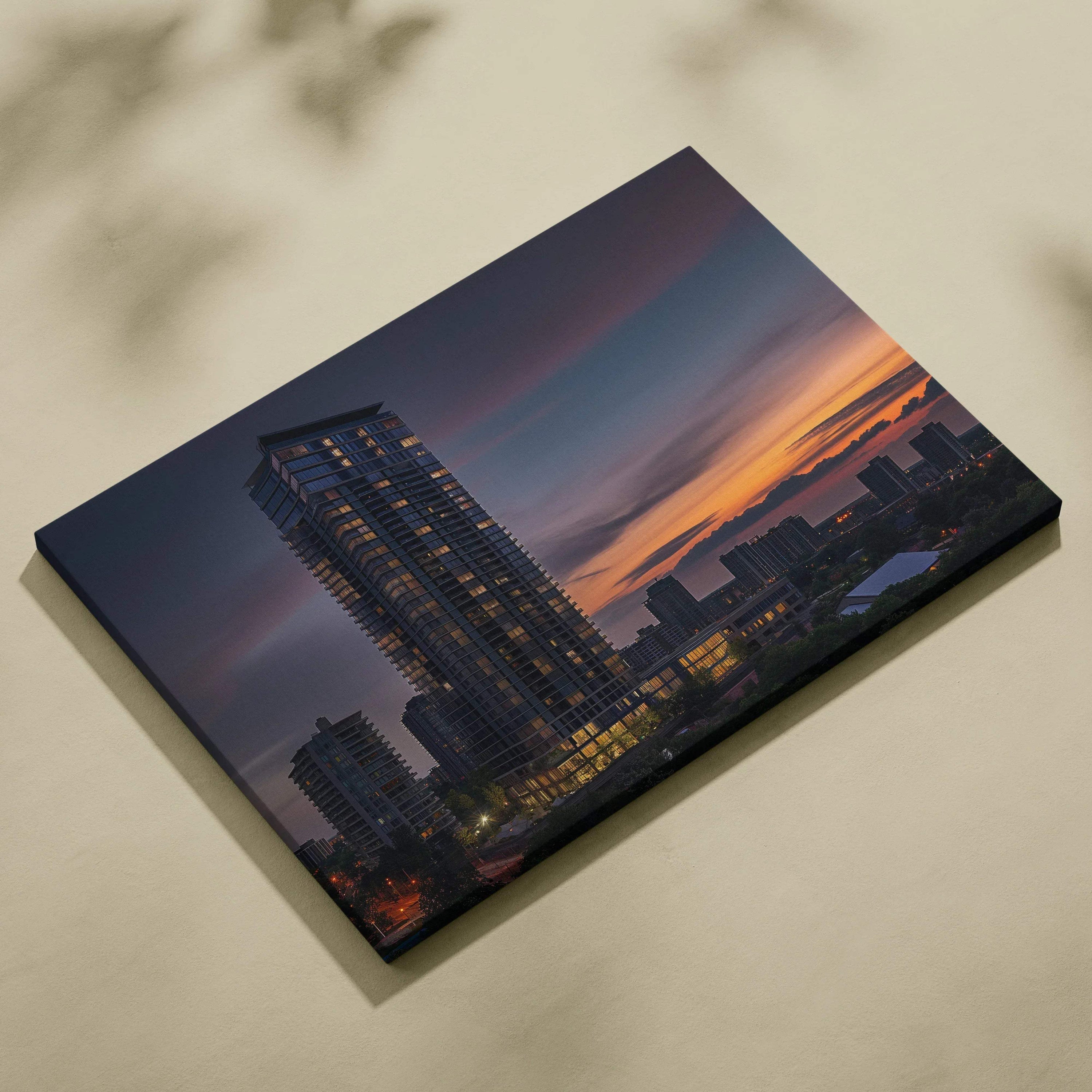 Digital canvas wall art featuring a tall modern building at sunset with warm city lights and a colorful sky background.