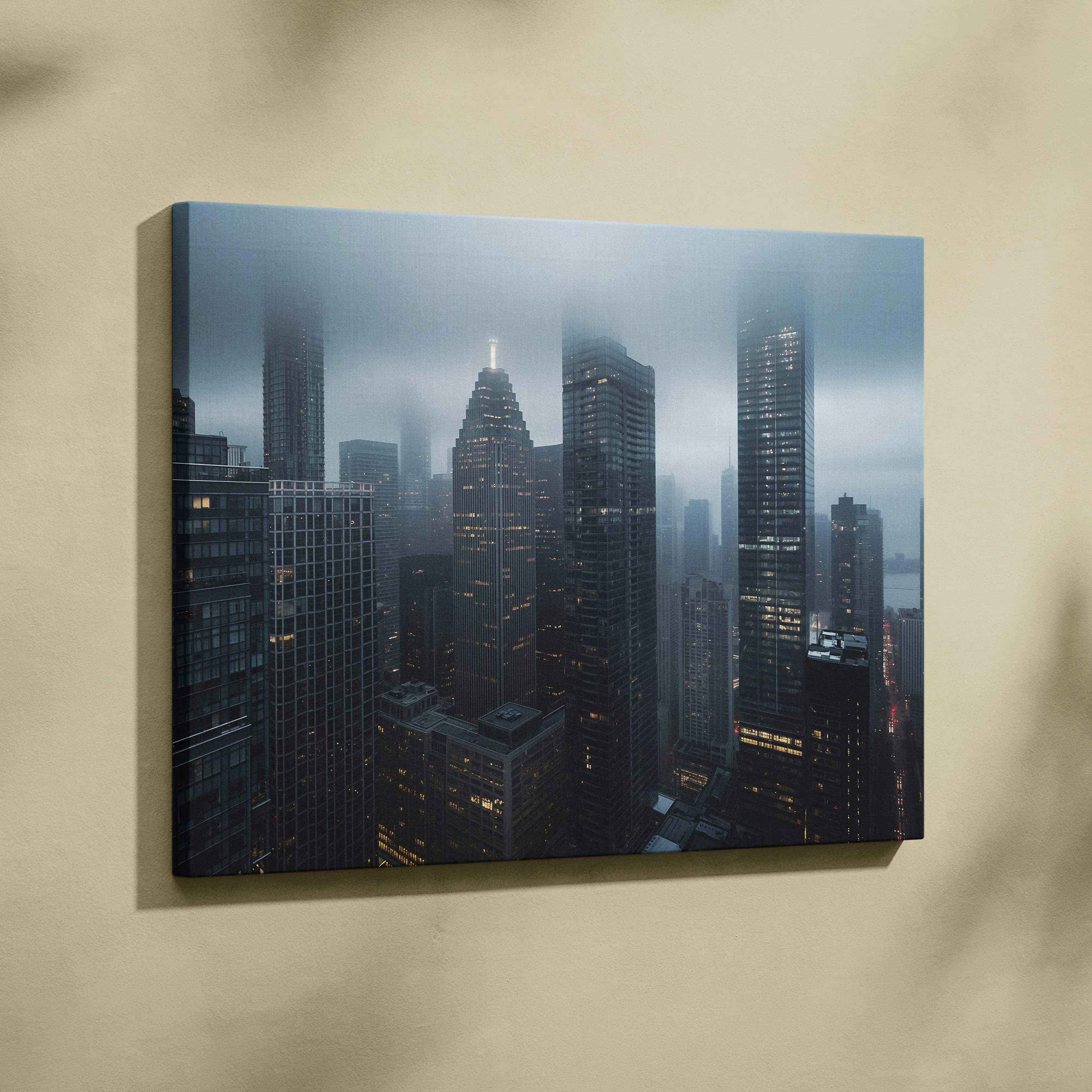 Moody cityscape architecture canvas wall art in black and gray featuring a misty urban skyline with illuminated skyscrapers