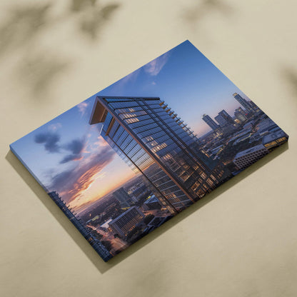 Canvas wall art print featuring a high-resolution digital cityscape with modern buildings at sunset.
