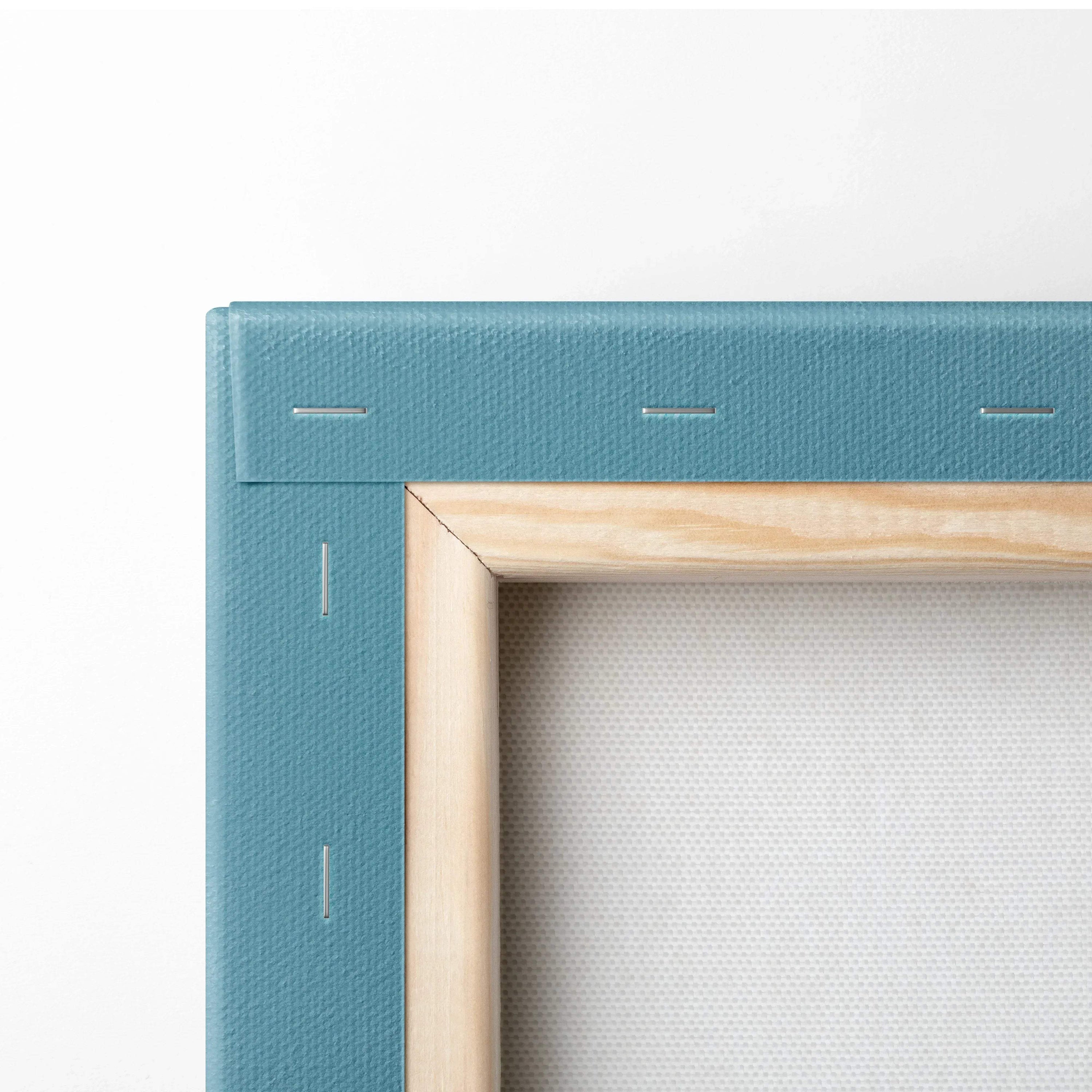 Close-up of light wood-framed canvas with blue textured fabric backing and visible staples.