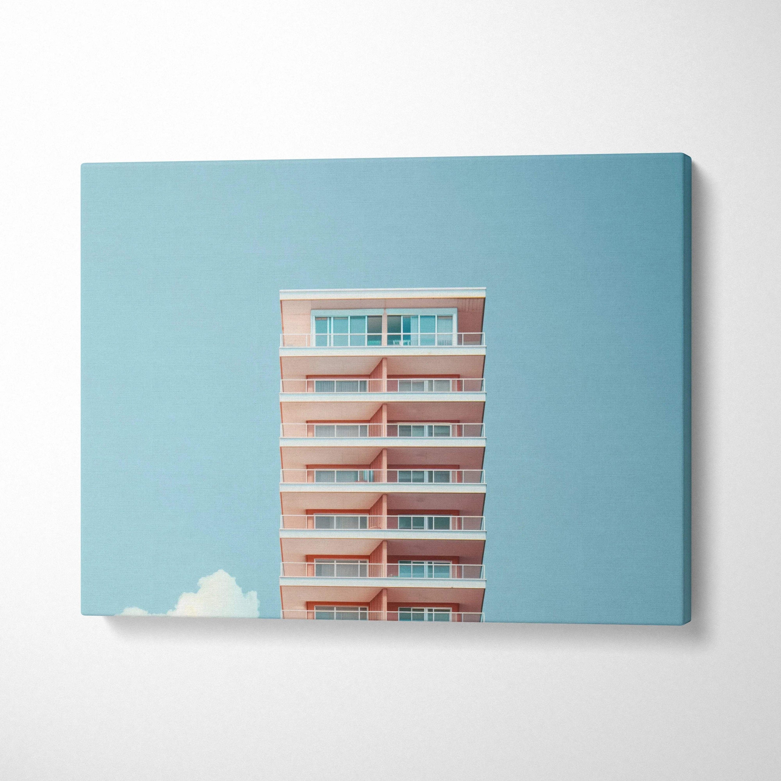 Canvas wall art featuring digital design of modern high-rise building against clear blue sky.