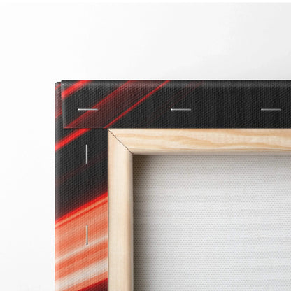 Close-up of stretched canvas corner with vibrant red and black abstract wall art and wooden frame edges.