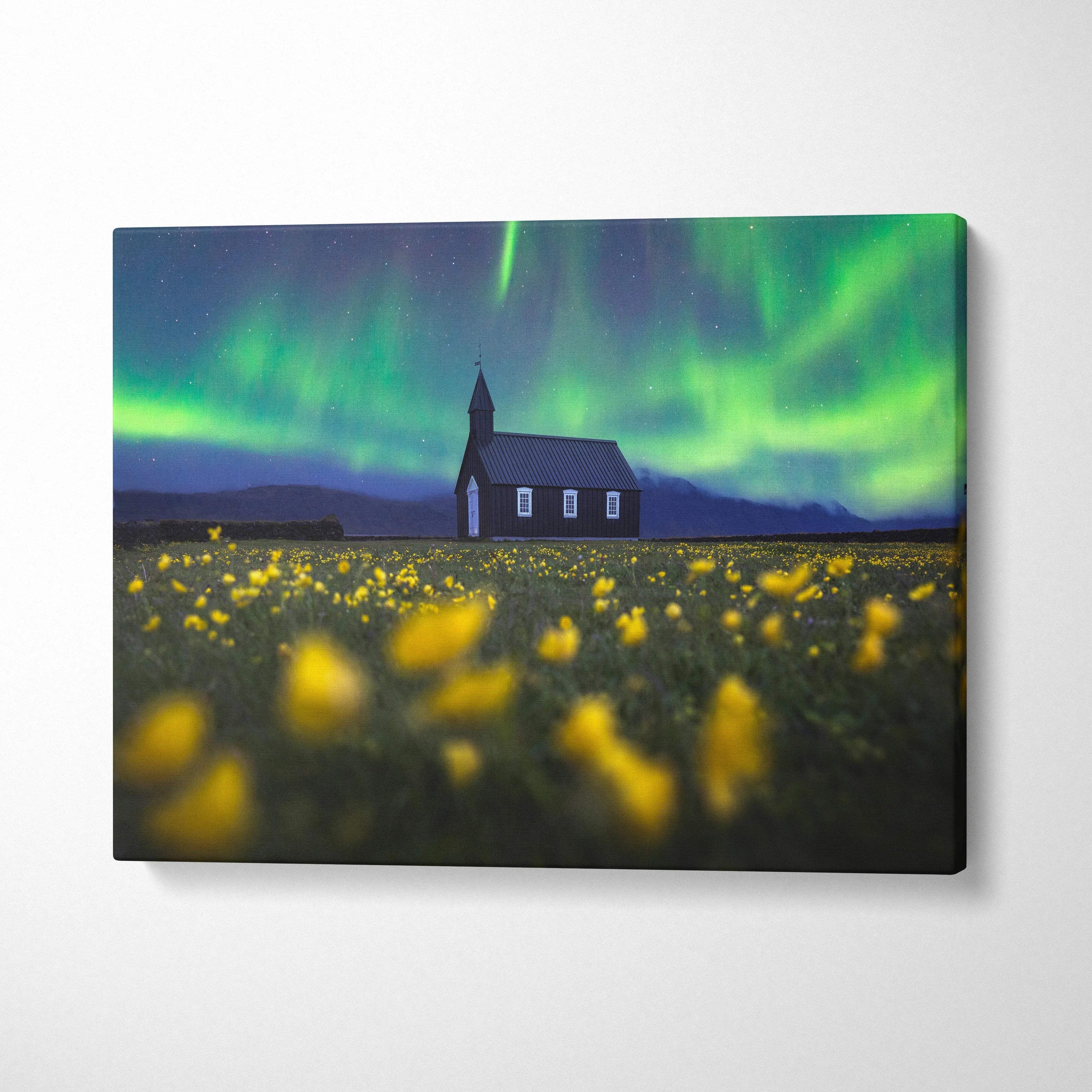 Nocturnal Vision: Aurora borealis over wooden church in wildflower field canvas art