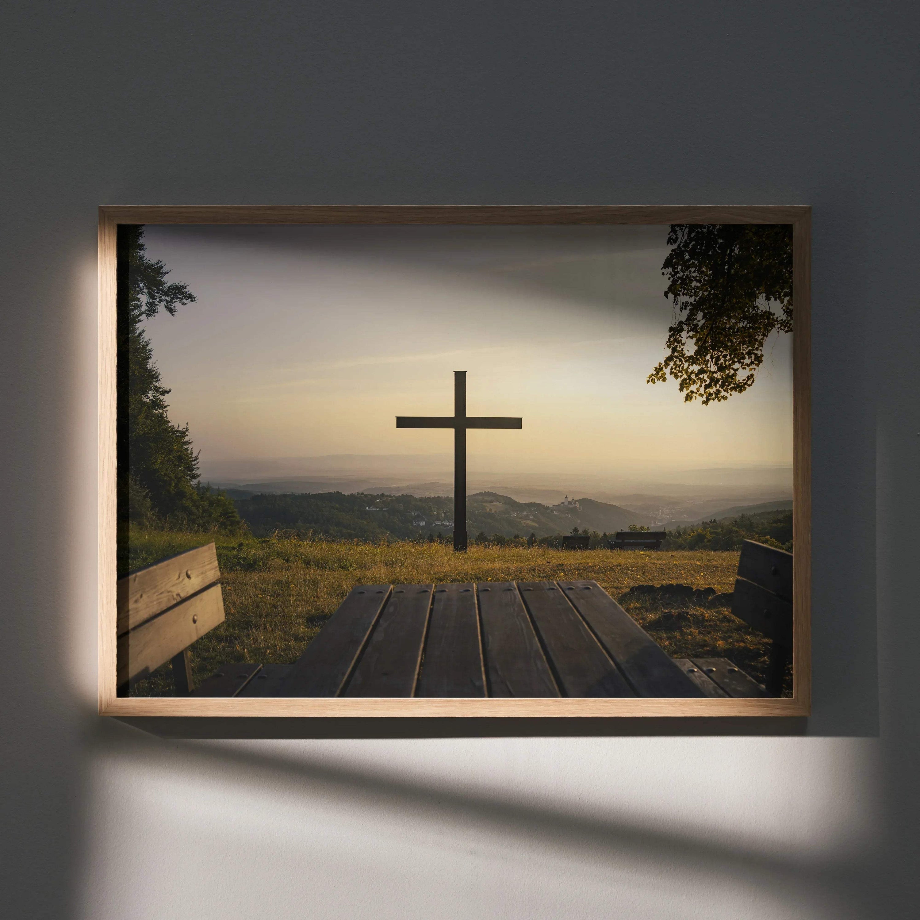 Inspirational faith wall art poster featuring a wooden cross at sunset with a bench and scenic hillside view.