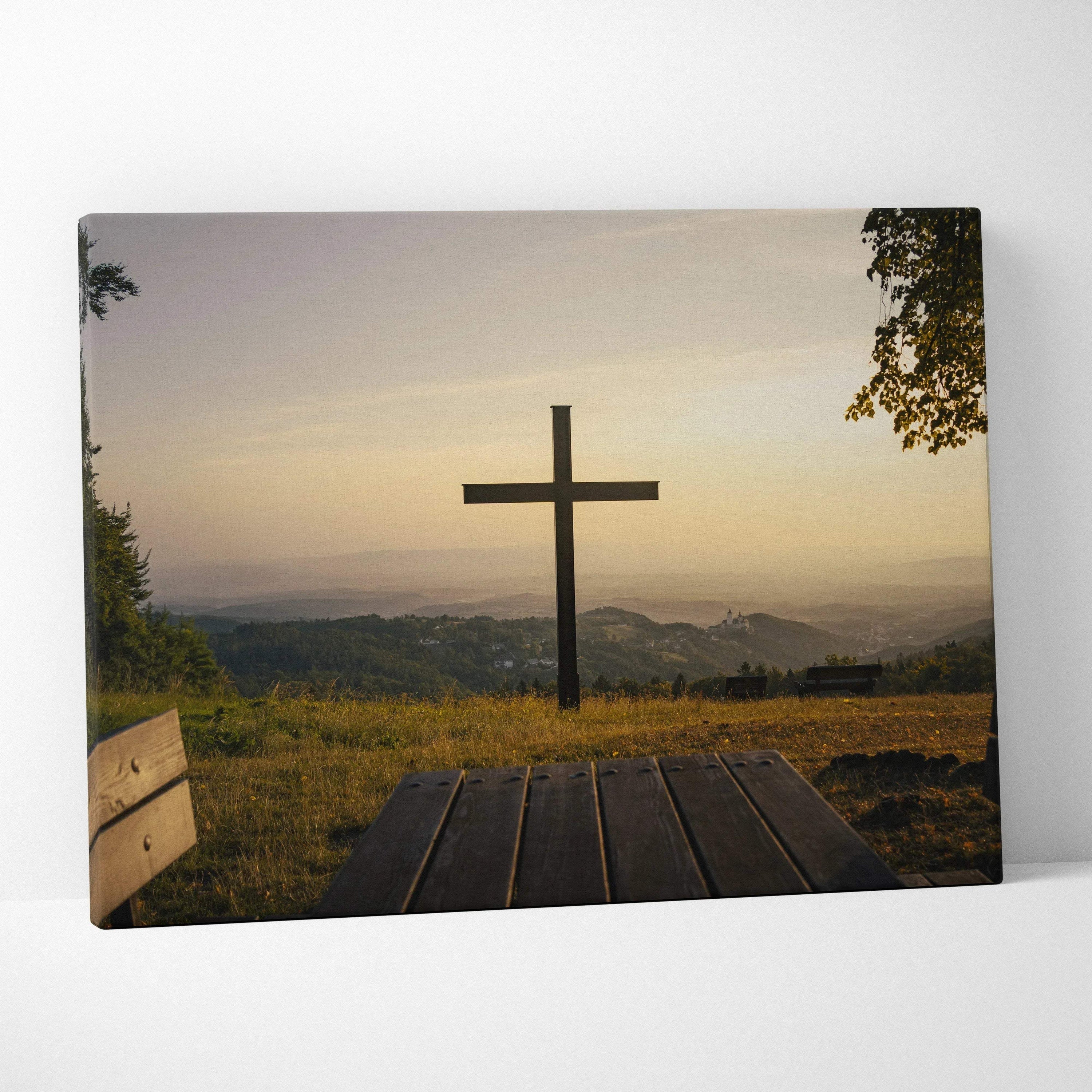 Canvas wall art featuring a wooden cross at sunset over rolling hills with golden light.