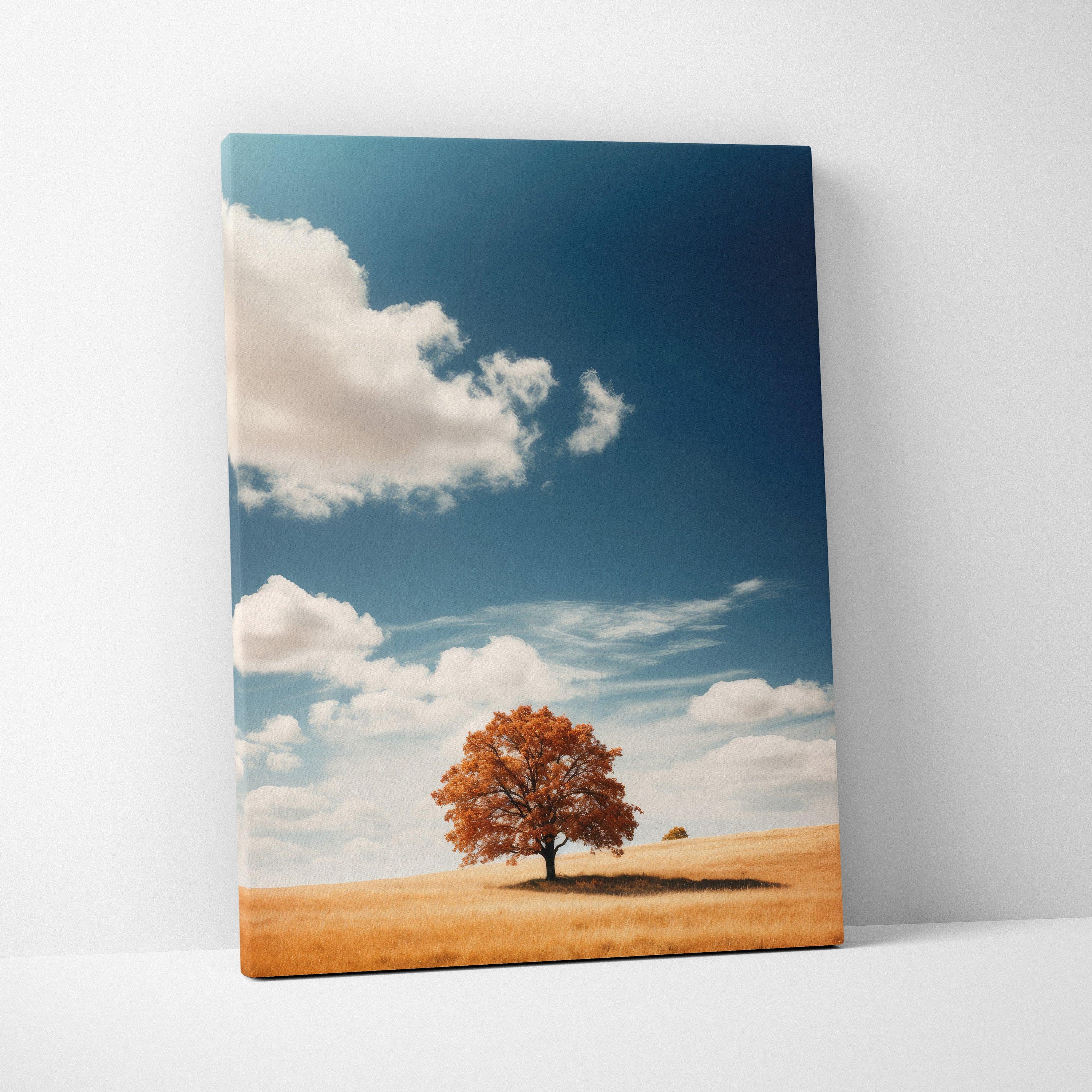 Canvas wall art featuring a solitary autumn tree with orange leaves under a blue sky with white clouds.