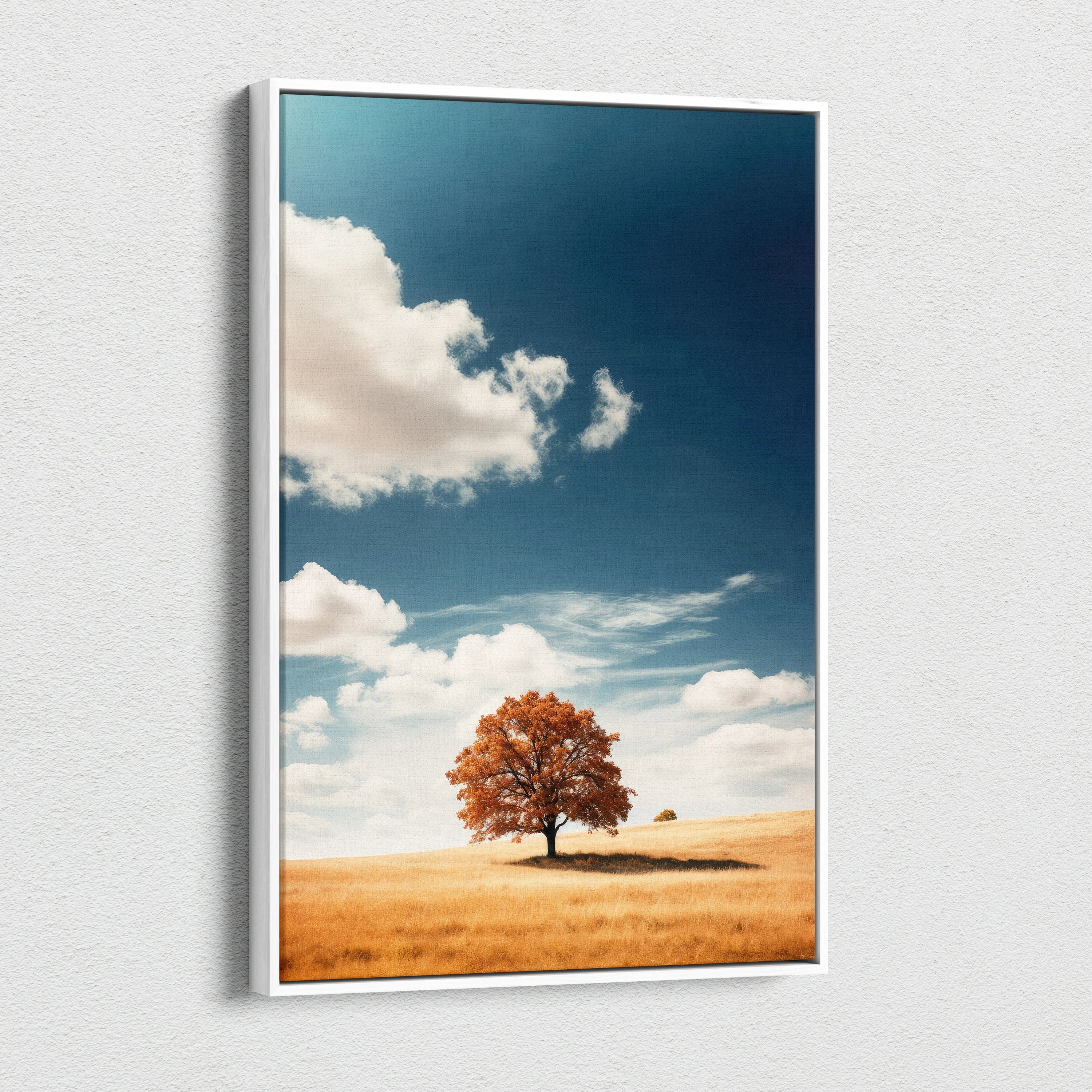 Canvas wall art featuring a solitary autumn tree in a golden field under a bright blue sky with scattered clouds.