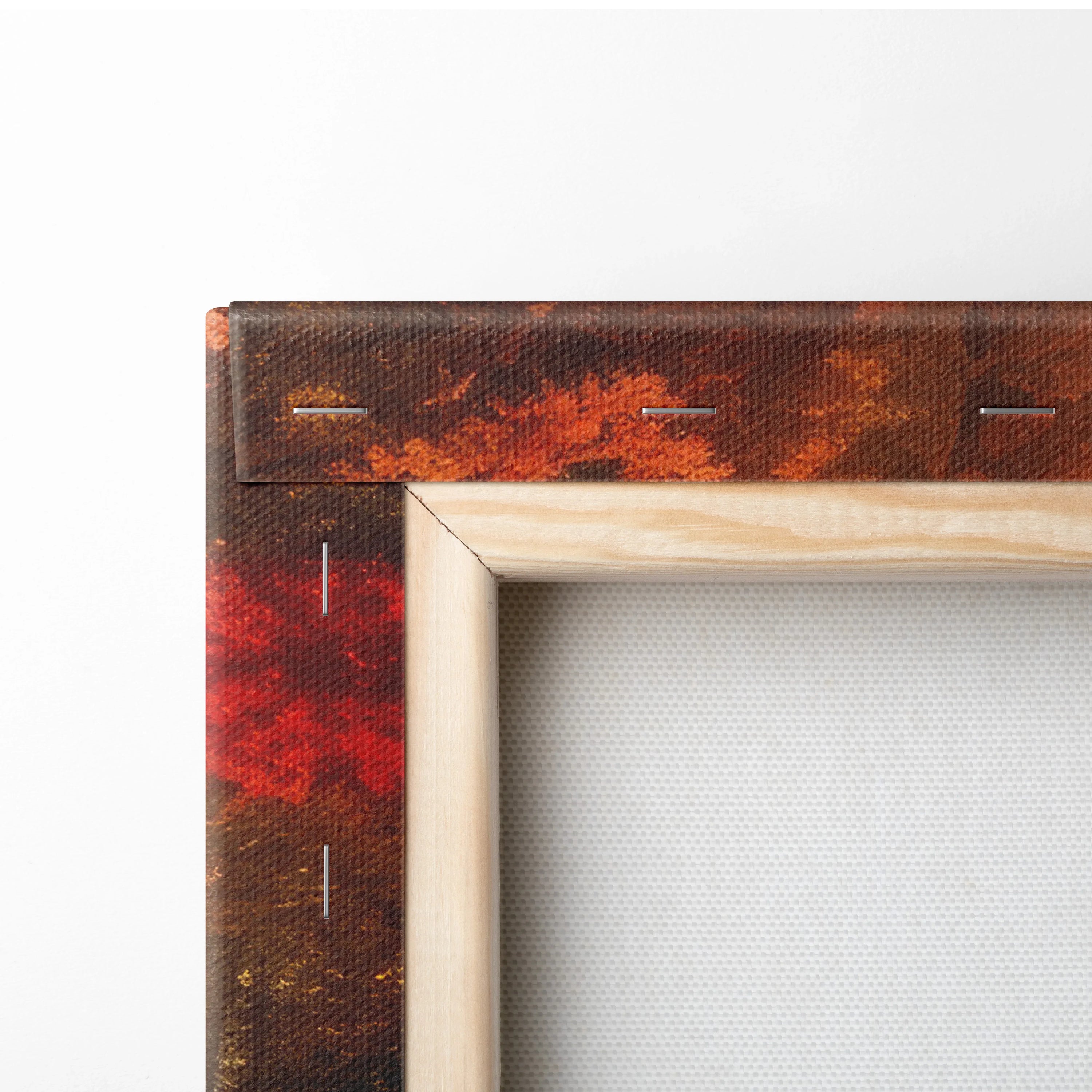 Close-up of wooden frame corner on canvas wall art featuring vibrant autumn foliage digital art with rich reds and oranges.