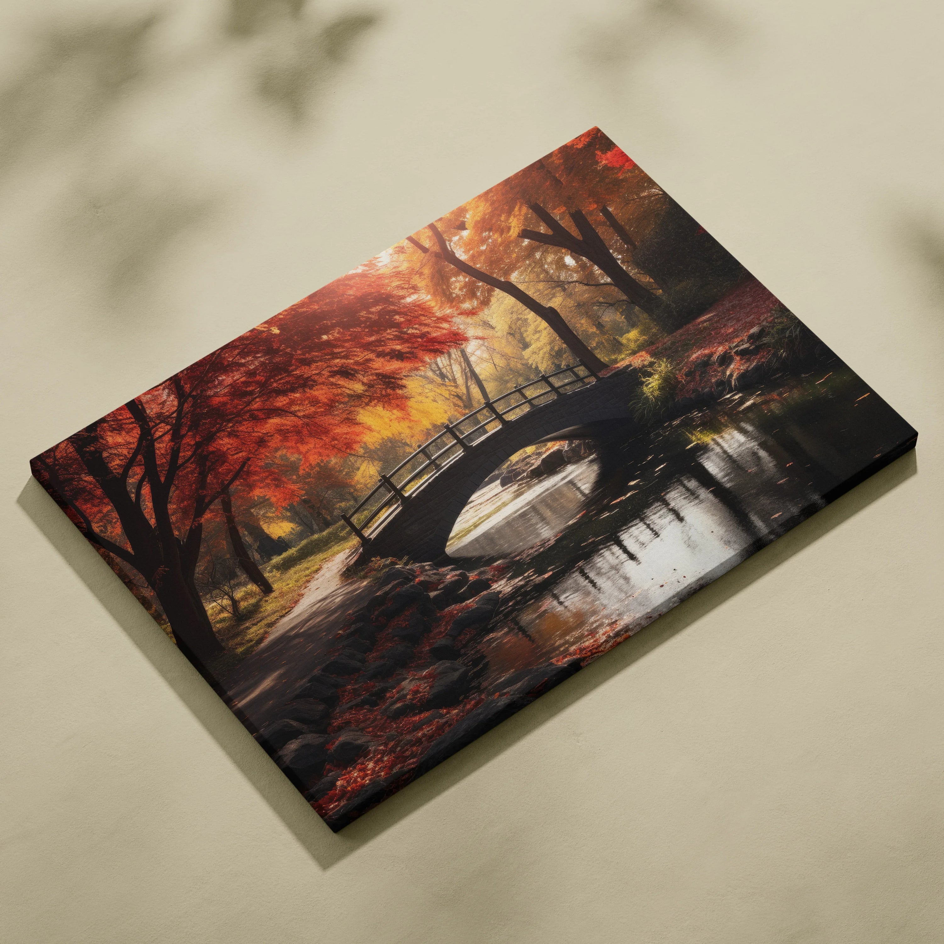 Autumn foliage canvas art with vibrant red and orange trees over serene forest stream and wooden bridge wall art.