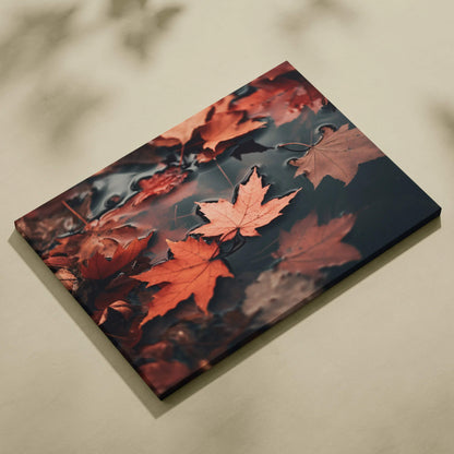 Autumn leaves floating on water in vibrant reds and oranges canvas wall art.