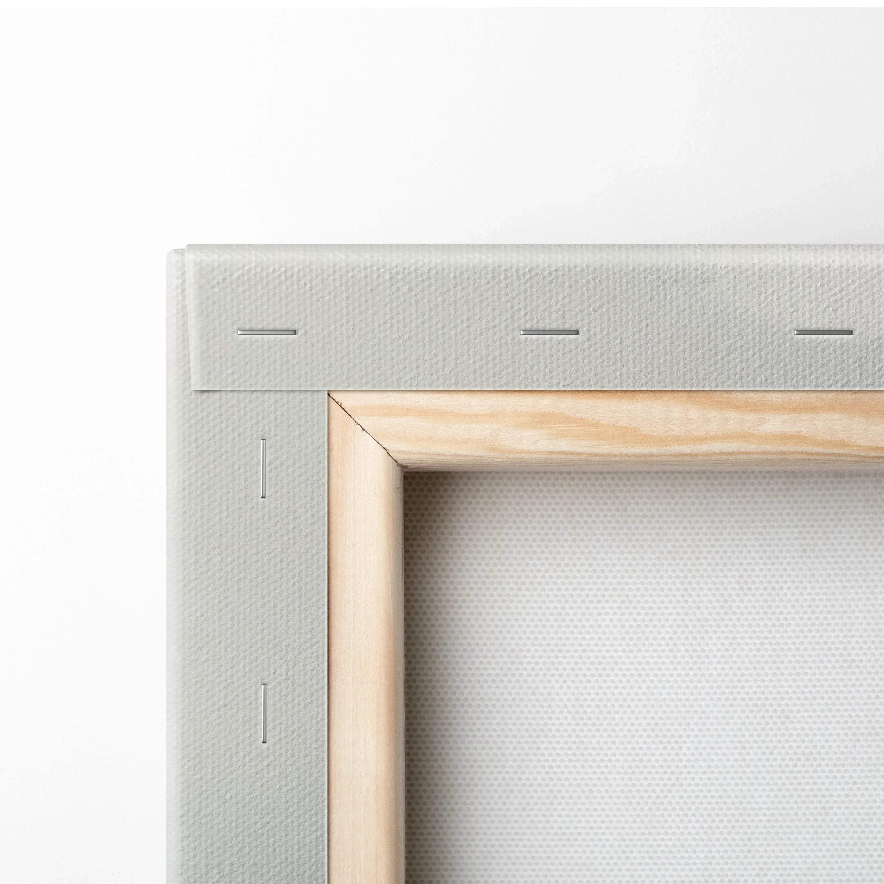 Close-up of stretched blank canvas on wooden frame showing staple-secured edges for wall art canvas art.