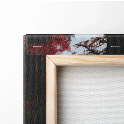 Close-up of wooden frame corner and vibrant autumn leaves on canvas wall art with red, orange, and gold tones.