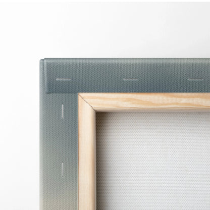 Close-up of wooden frame and stapled gray canvas fabric on vertical wall art canvas.