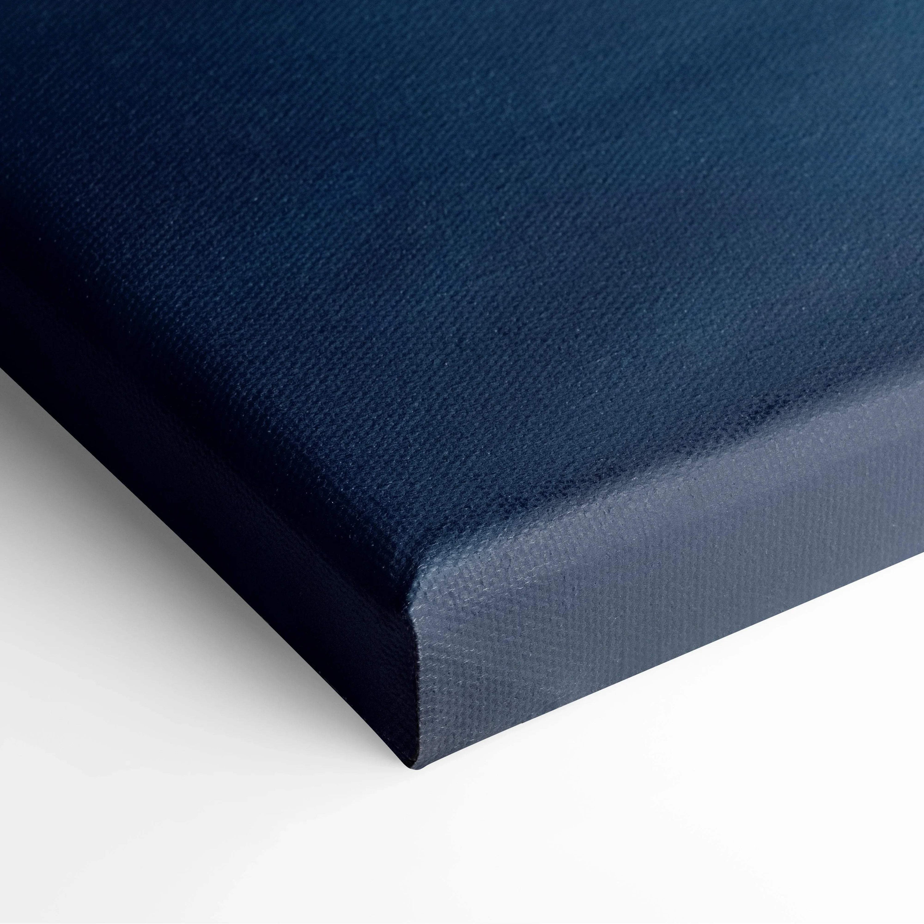 Close-up of textured dark blue canvas art corner on stretched frame for wall art display.