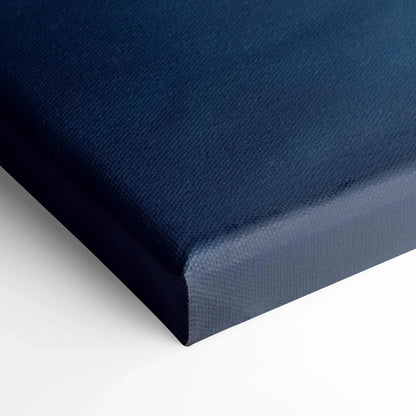 Close-up of textured dark blue canvas art corner on stretched frame for wall art display.