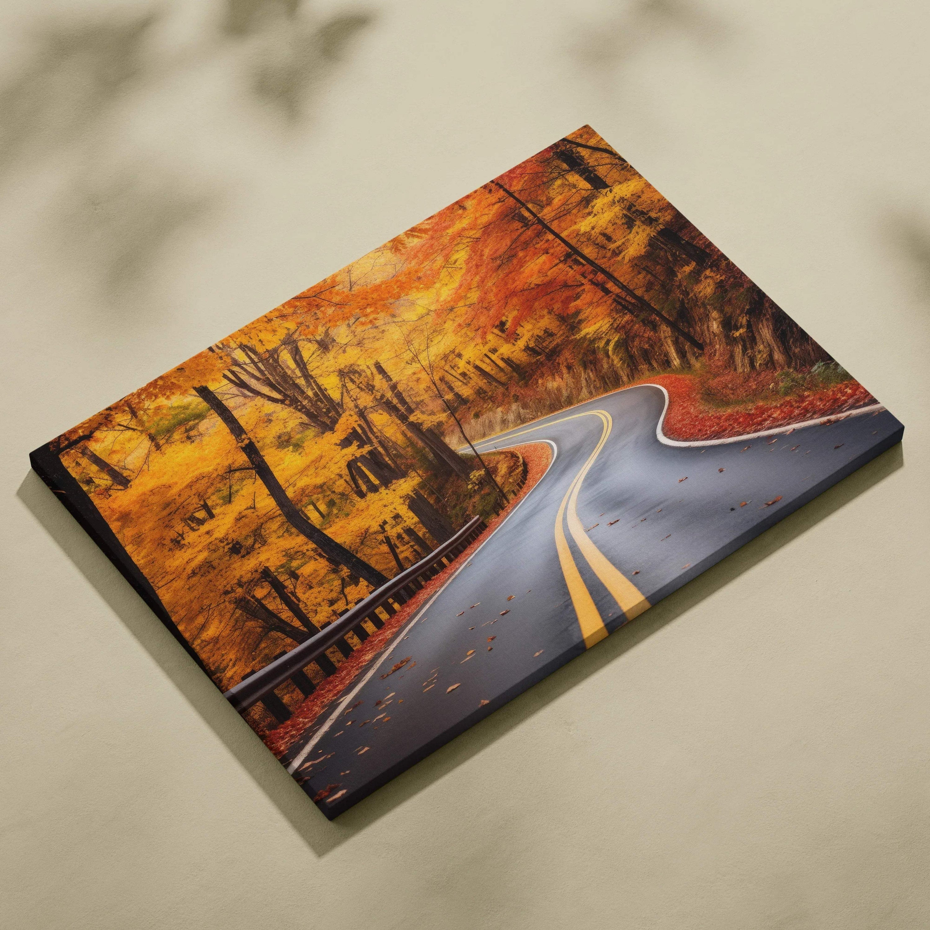 Canvas art featuring a winding road through vibrant golden autumn trees with fallen leaves, wall art decor.