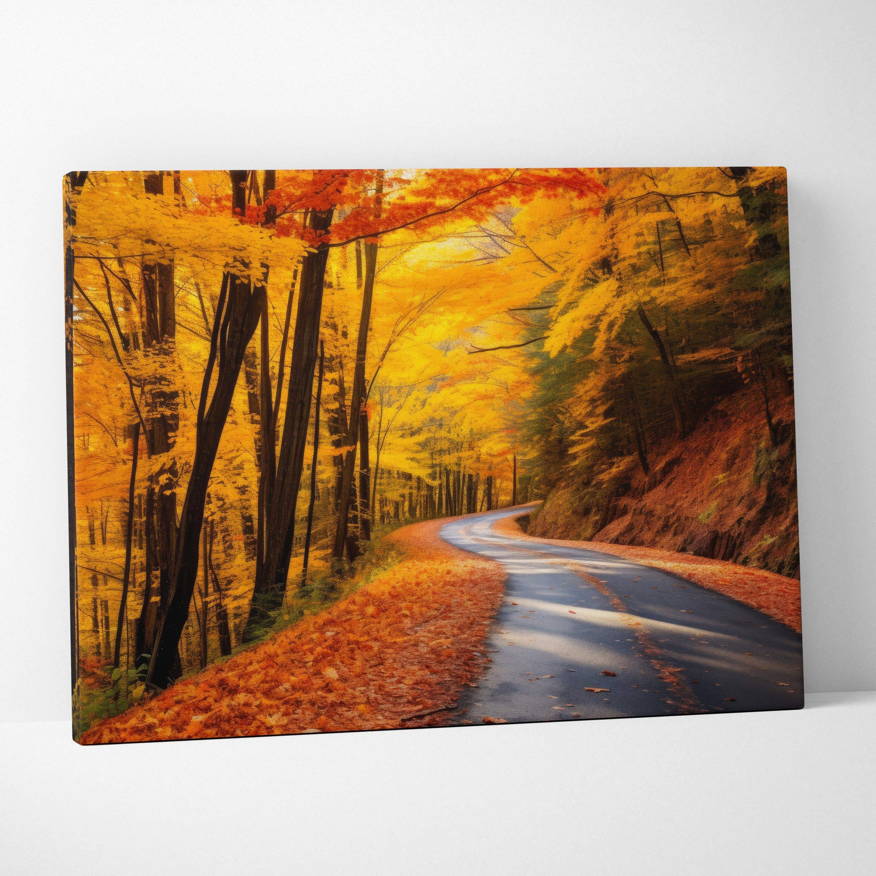 Autumn canvas art featuring a winding road through vibrant fall foliage wall art in warm orange and yellow tones.