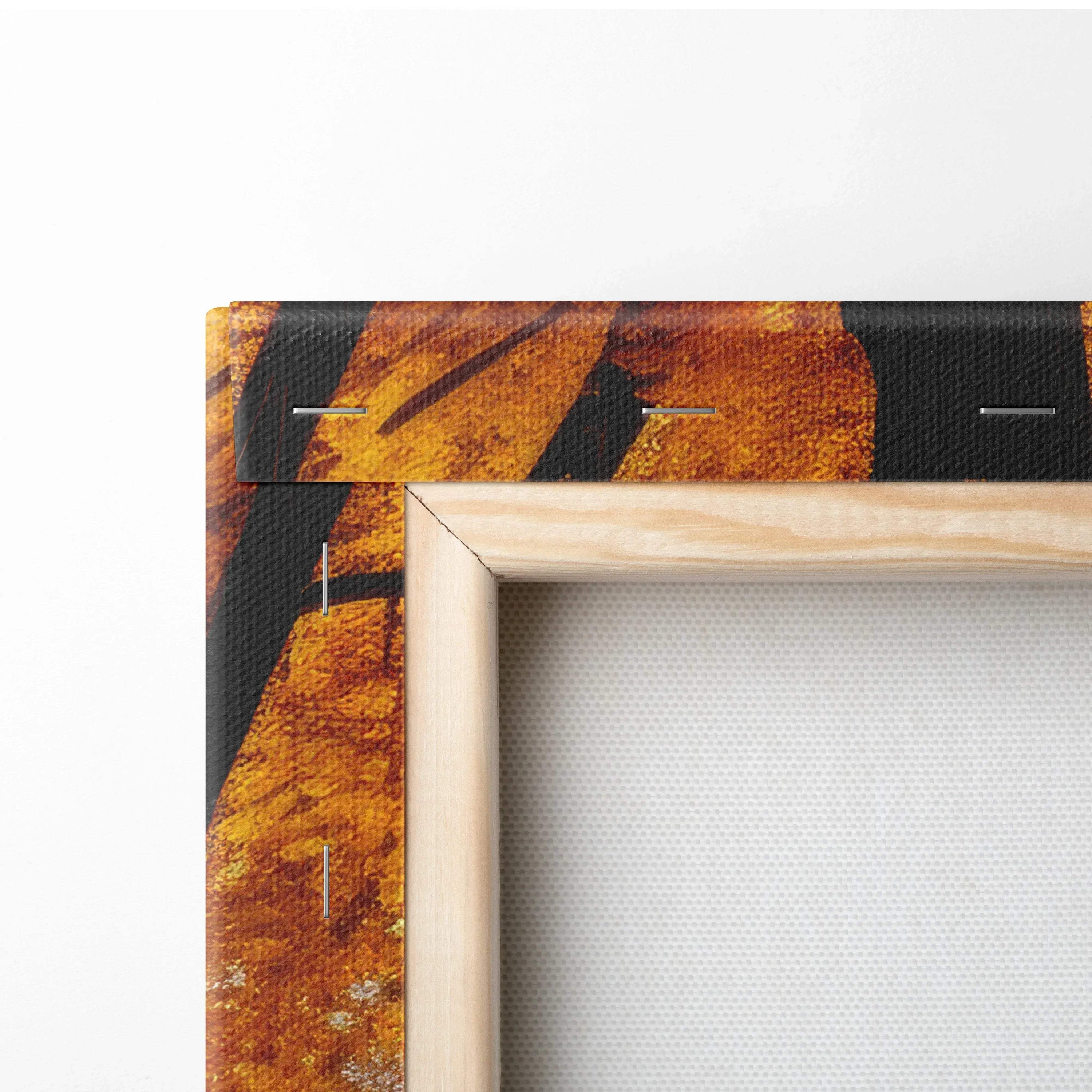 Corner of stretched canvas wall art with vibrant autumn leaves in golden orange tones and natural wood frame.