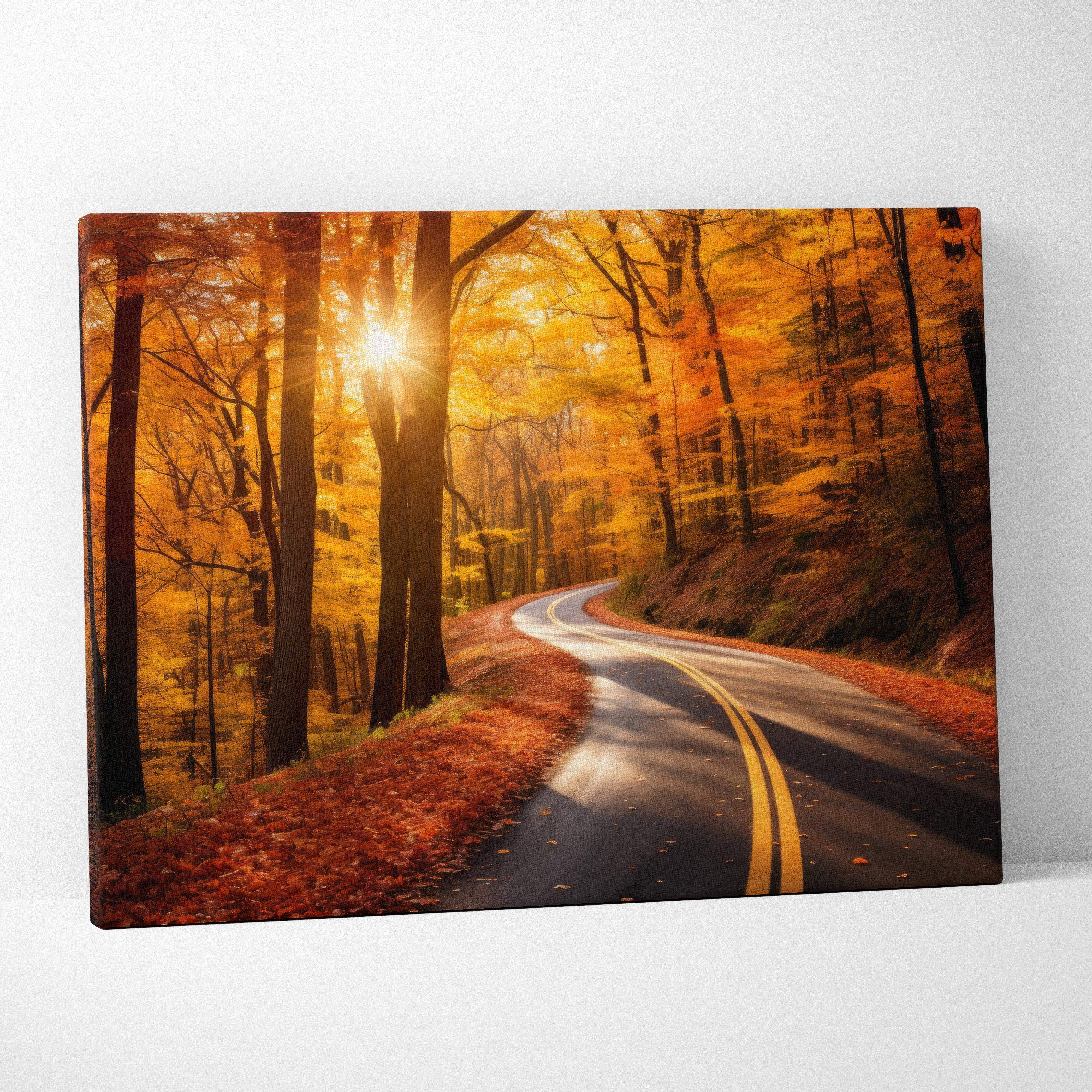 Canvas print of a winding forest road in autumn with golden leaves and warm sunlight filtering through trees