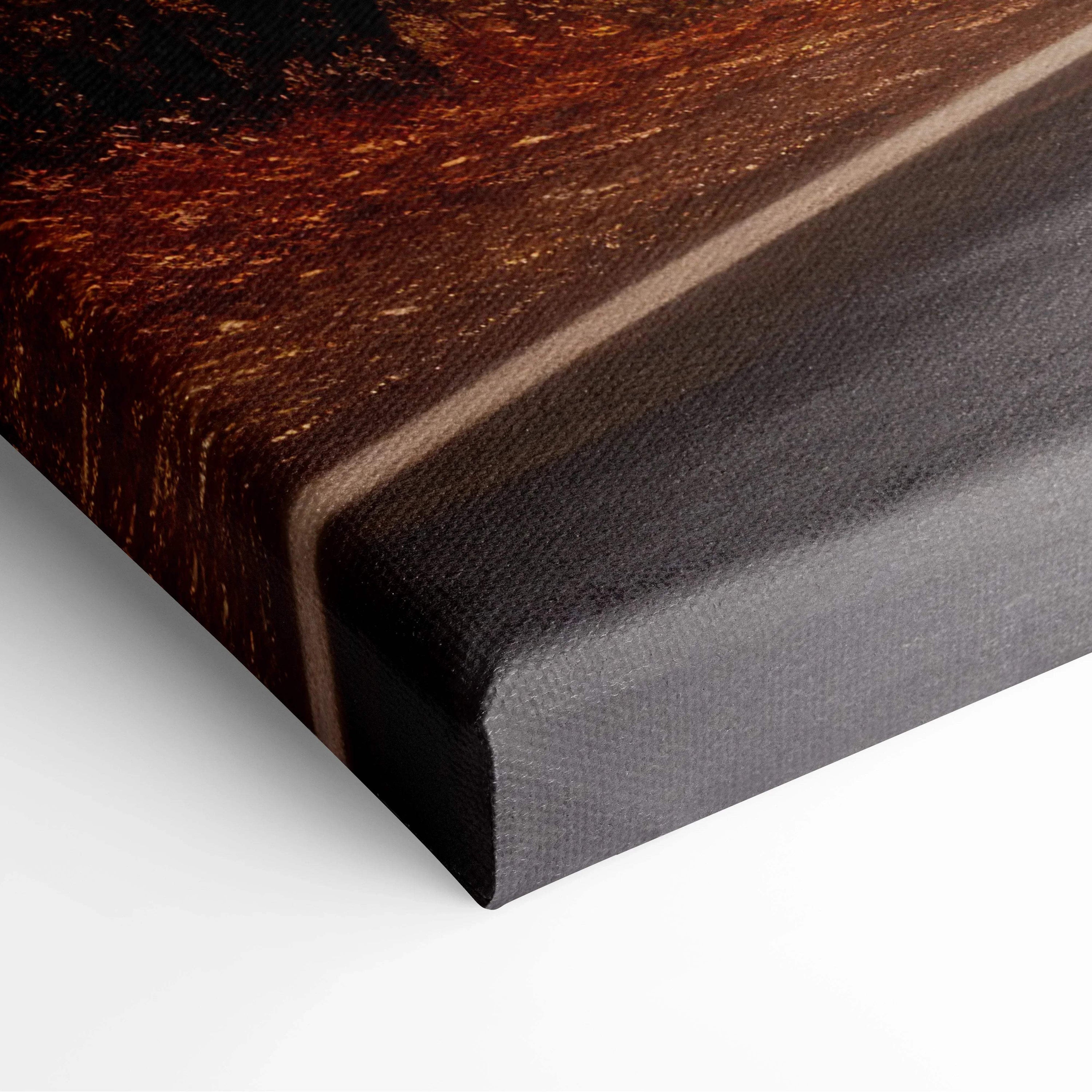 Close-up of canvas art edge featuring high-resolution autumn landscape with golden leaves and winding road.