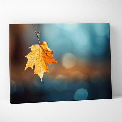 Autumn leaf hanging on branch against blurred blue and brown background canvas wall art.