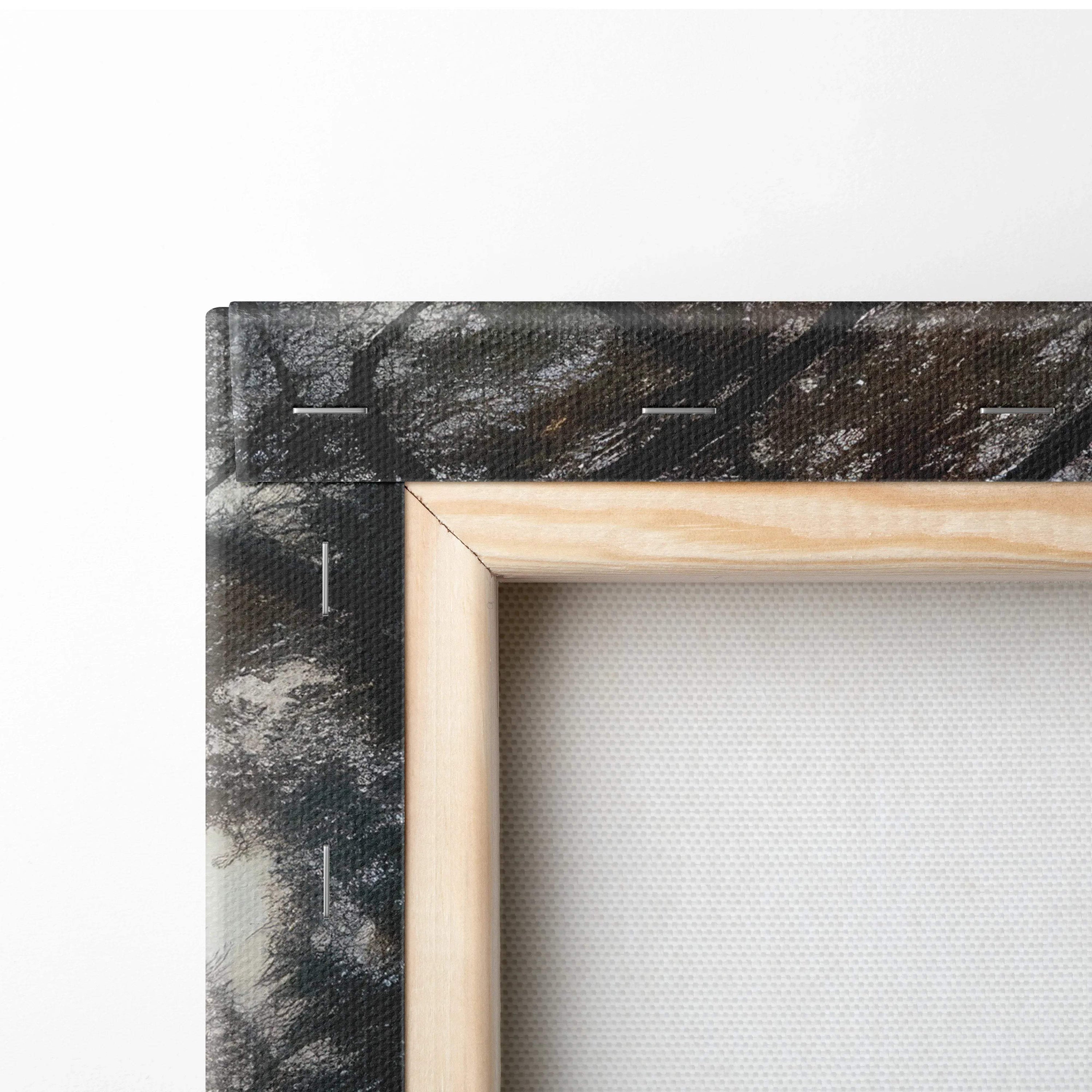 Close-up of wooden stretcher frame and black painted edge on canvas wall art with textured finish.