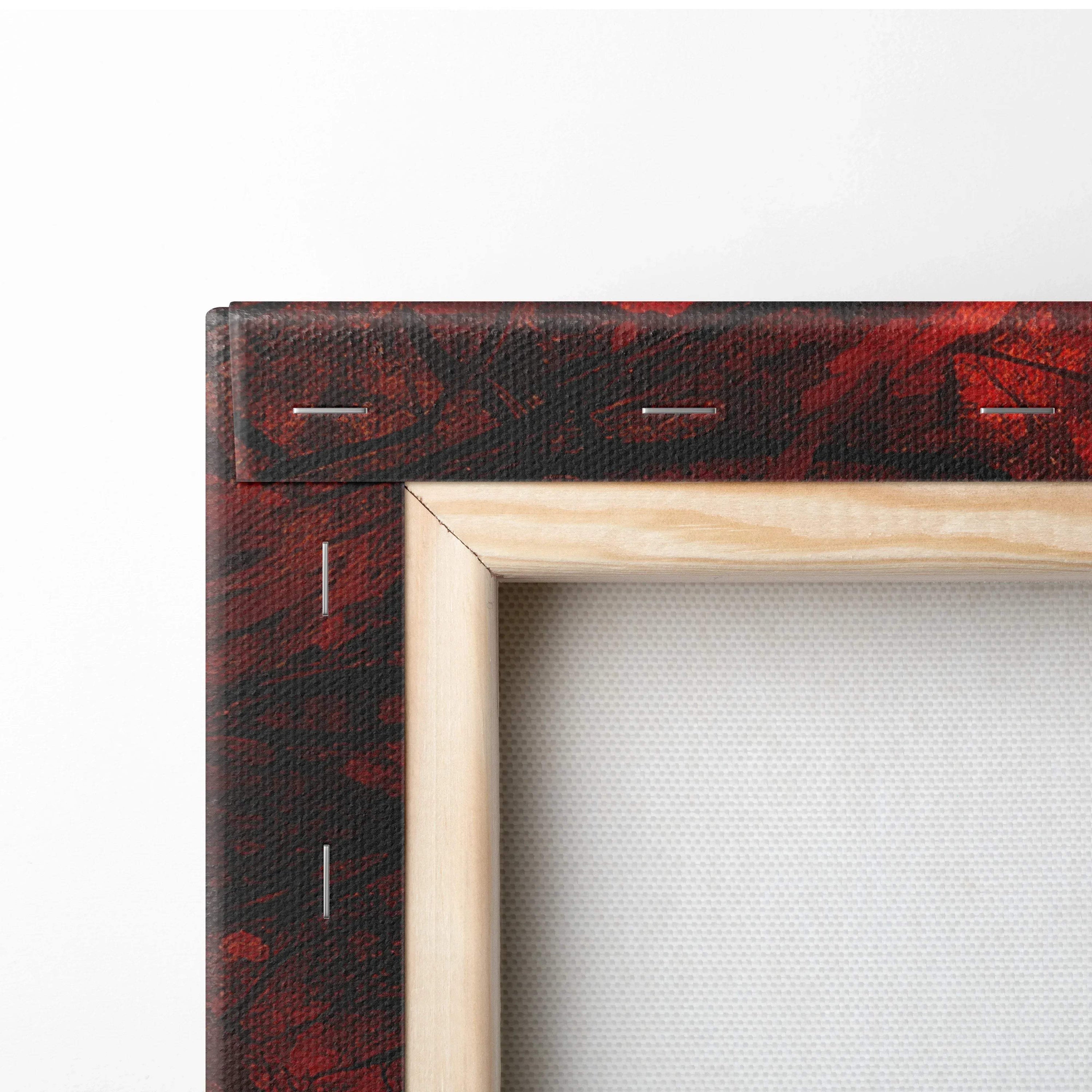 Close-up of canvas art corner showing wooden frame and autumn sunset foliage print in rich red and golden hues.