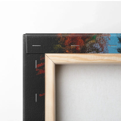 Close-up of wooden frame corner with vibrant autumn foliage canvas wall art and visible staples.