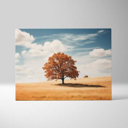 Canvas art of a vibrant autumn tree with orange leaves against a bright blue sky on a golden field wall art.