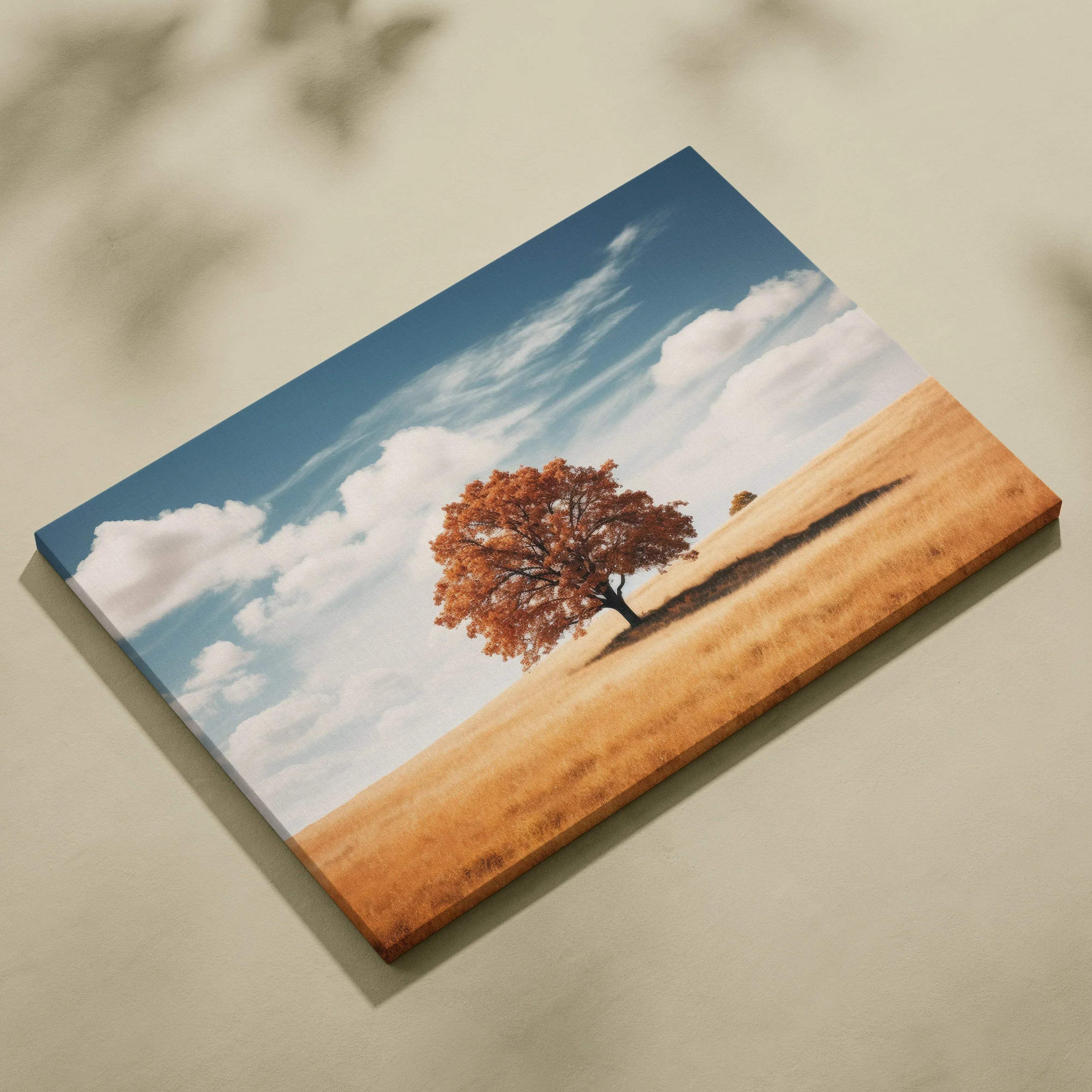 Canvas art featuring a solitary autumn tree with vibrant orange leaves against a blue sky and golden field wall art.