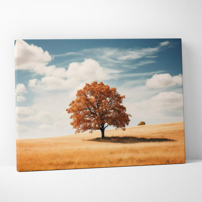 Canvas art featuring a solitary autumn tree with vibrant orange leaves on a golden field under a blue sky with white clouds.