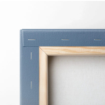 Close-up of wooden stretcher bars and blue canvas backing on wall art canvas frame.