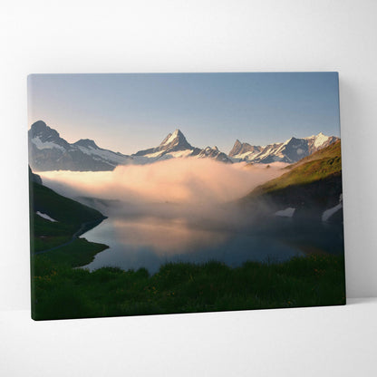 Canvas wall art depicting majestic snow-capped mountains above misty clouds at sunrise.
