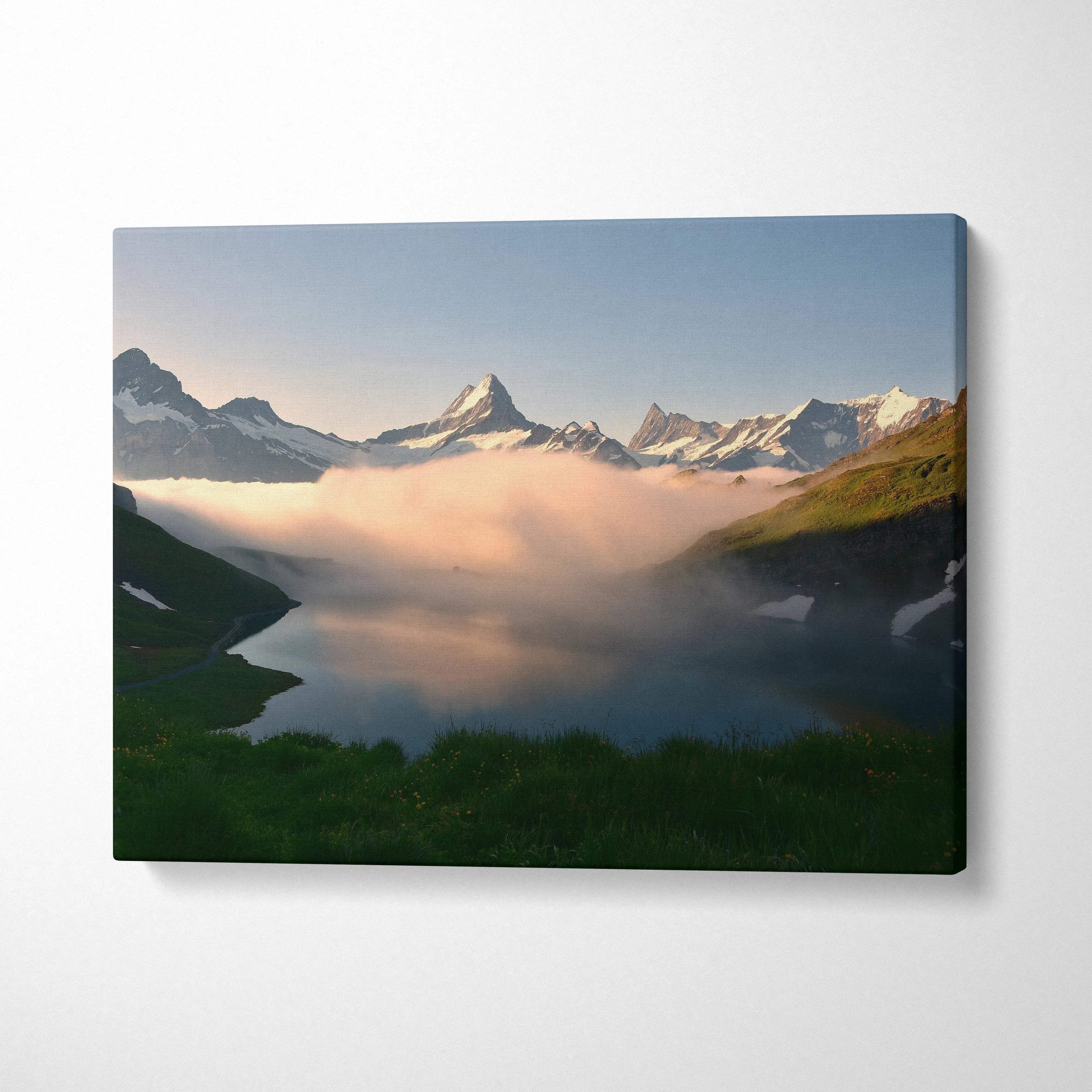 Canvas wall art featuring a serene mountain landscape with cloud cover and green foreground.