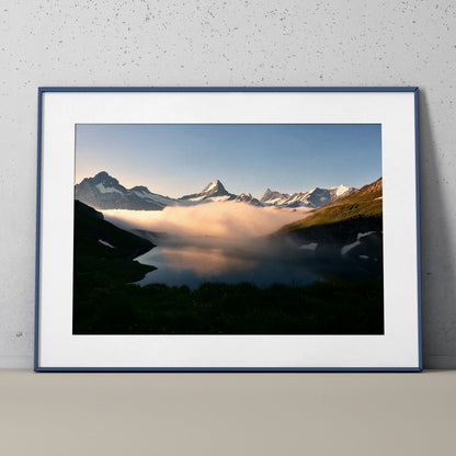 Mountain landscape poster with snowy peaks and misty clouds, framed wall art print.