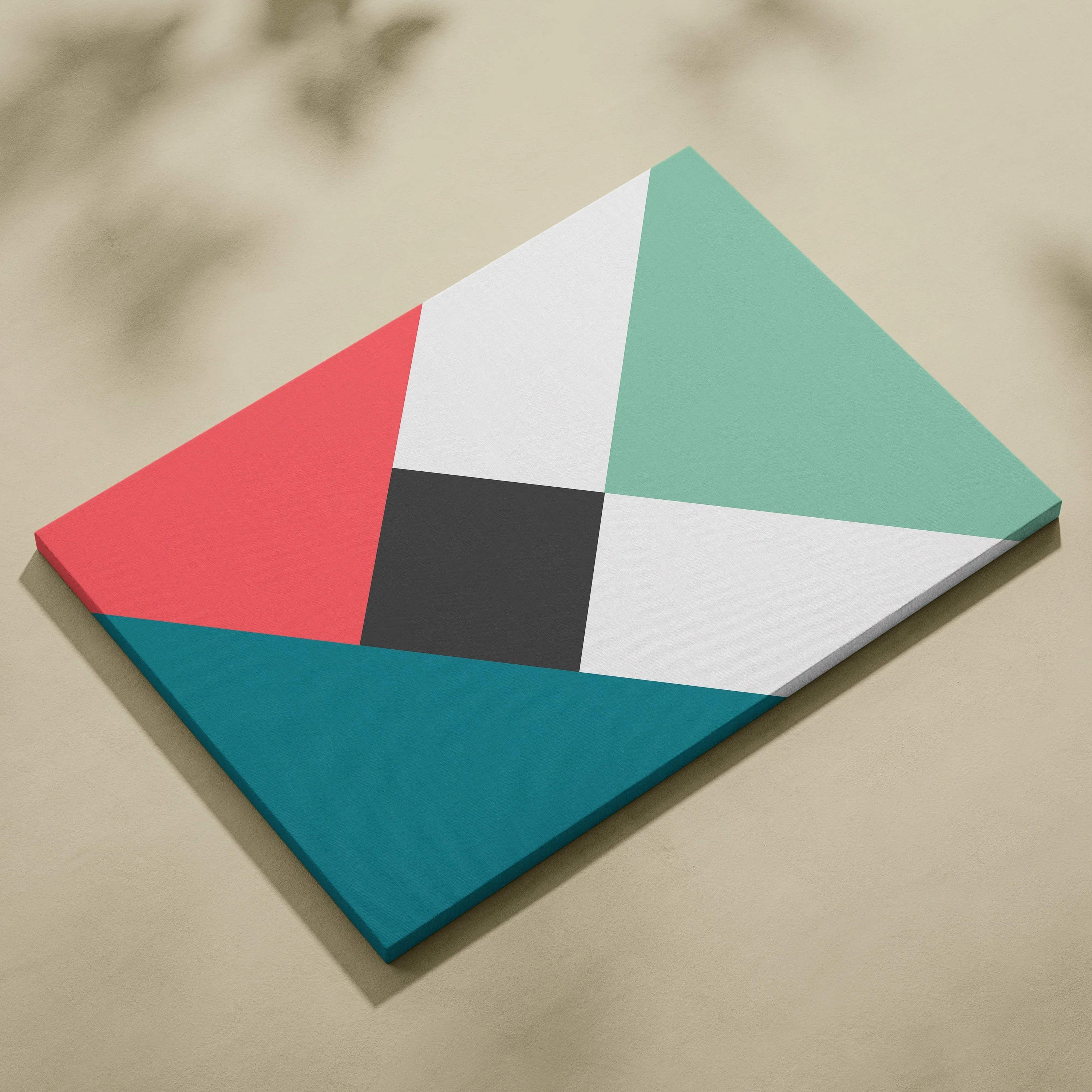 Modern geometric abstract canvas wall art with bold triangles and diamonds in coral, teal, mint green, white, and charcoal gray